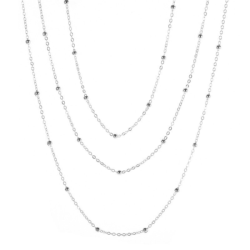 Fashionable women's layered necklace with multiple beaded chains, an elegant jewelry accessory.