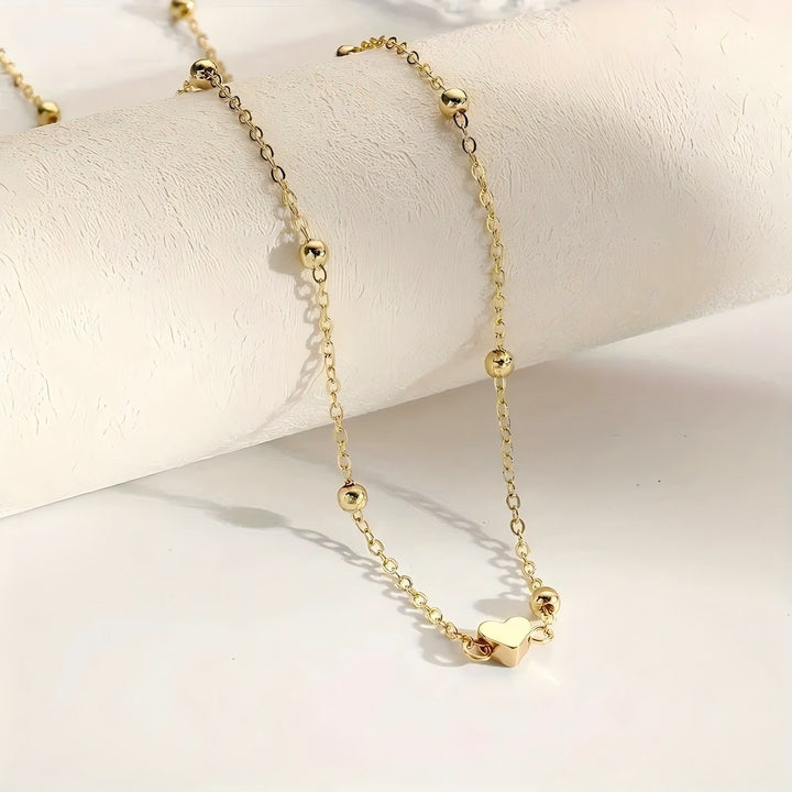 Elegant women's layered necklace featuring delicate chains & unique charms. A versatile fashion accessory for any outfit.