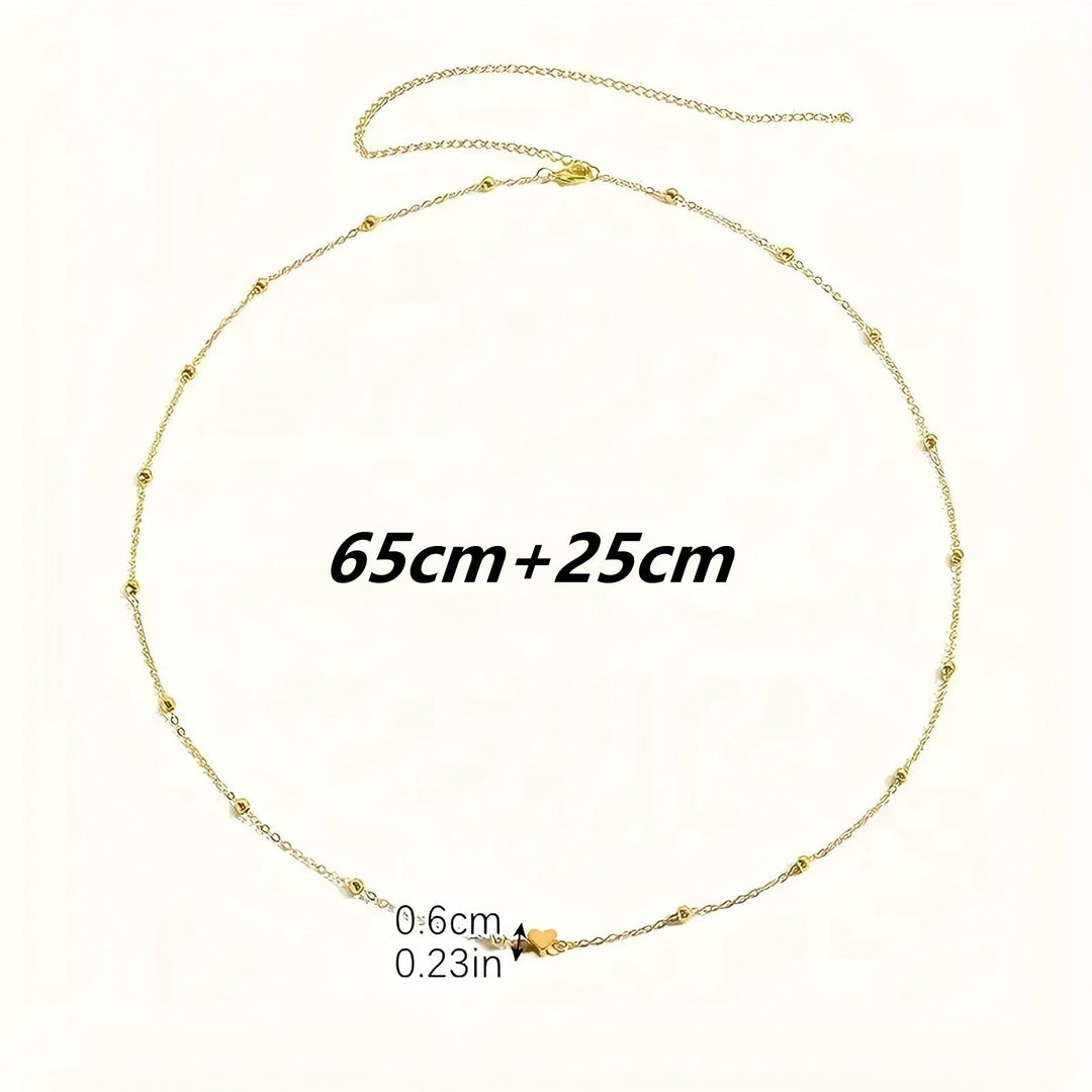 Gold-tone delicate layered charm necklace for women. Elegant fashion accessory with intricate details, adjustable length.