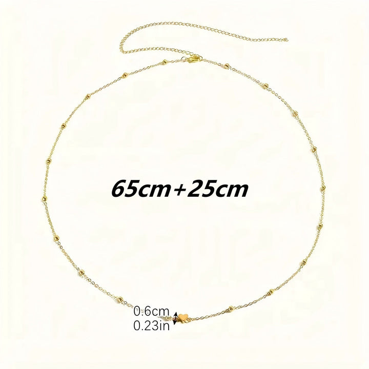 Gold-tone delicate layered charm necklace for women. Elegant fashion accessory with intricate details, adjustable length.
