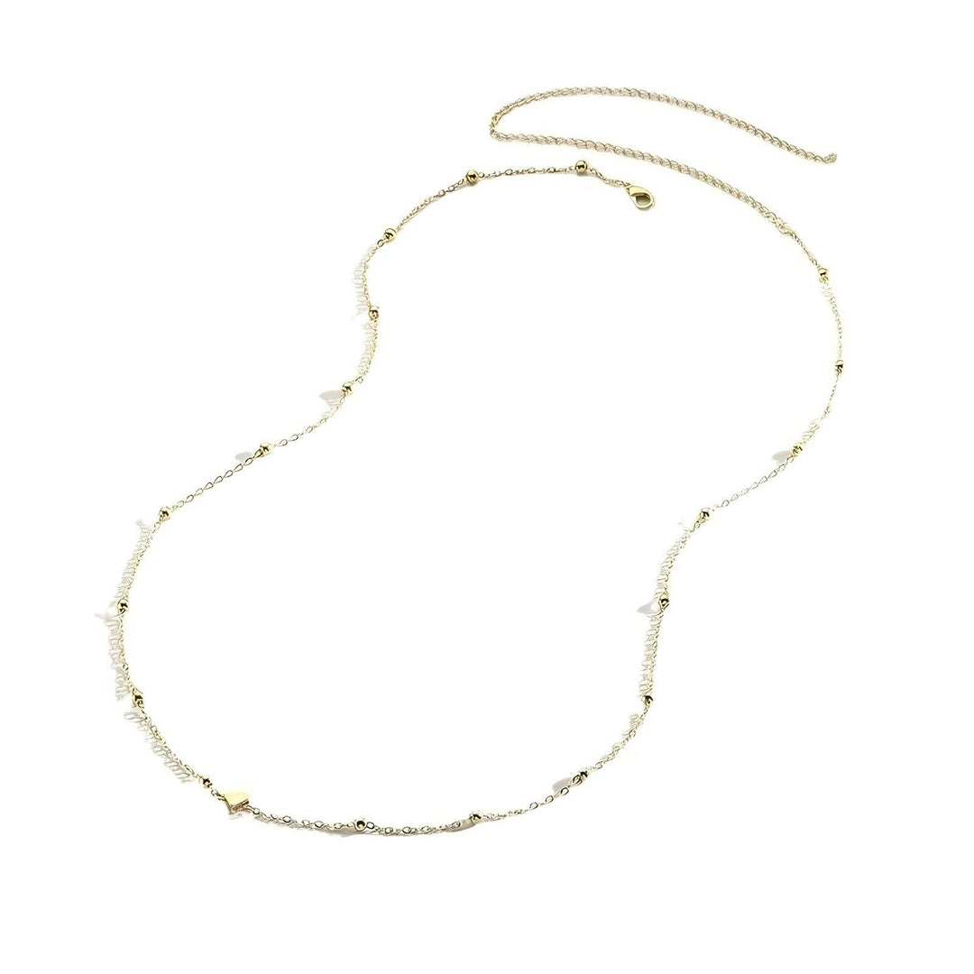 Delicate charm layered necklace for women. Features multiple fine chains & small, elegant charms. A chic fashion accessory.