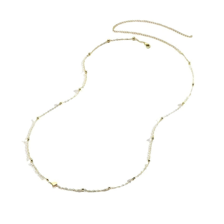 Delicate charm layered necklace for women. Features multiple fine chains & small, elegant charms. A chic fashion accessory.