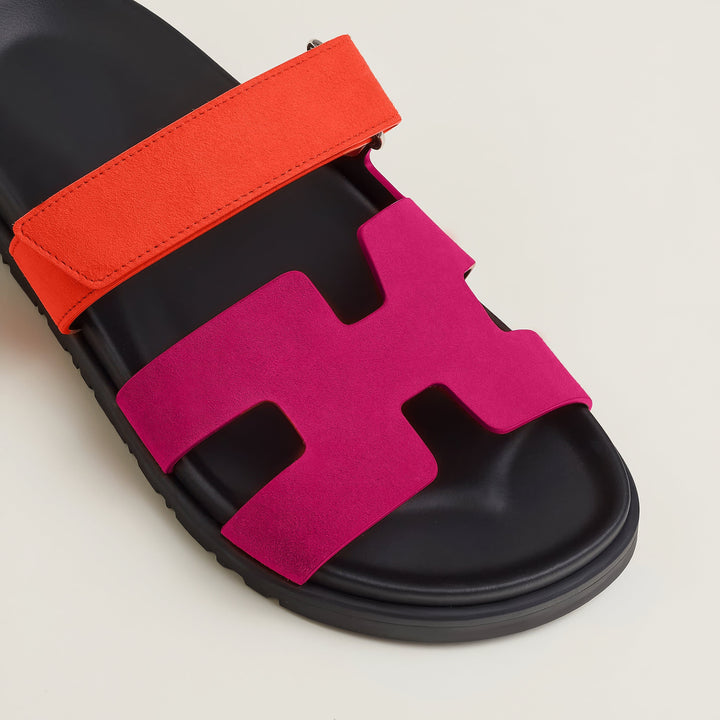 Close-up on the adjustable buckle of the elegant women's leather strap sandals for a custom fit.
