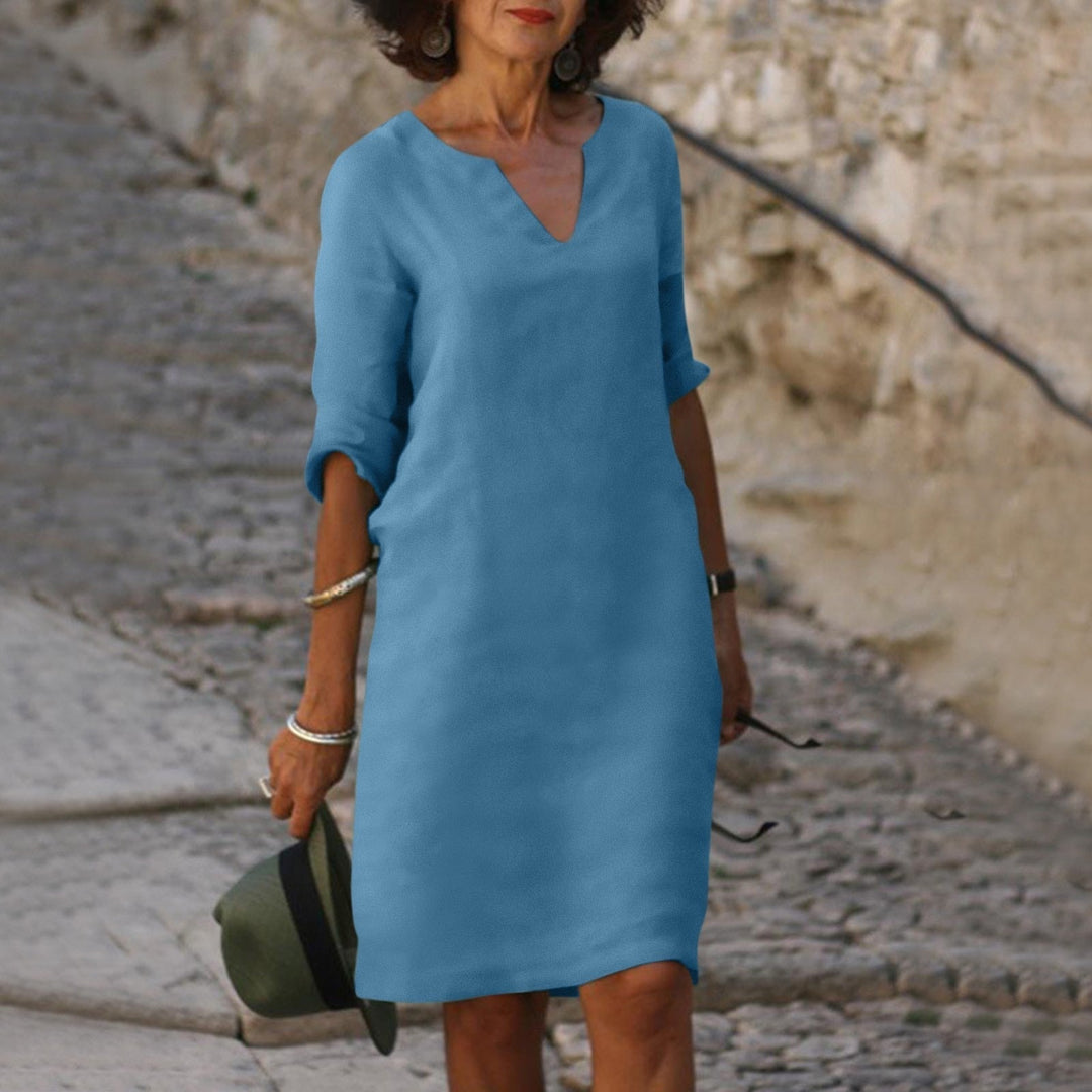 Stylish women's linen dress, V-neck, elegant and comfortable for summer days and warm weather apparel.