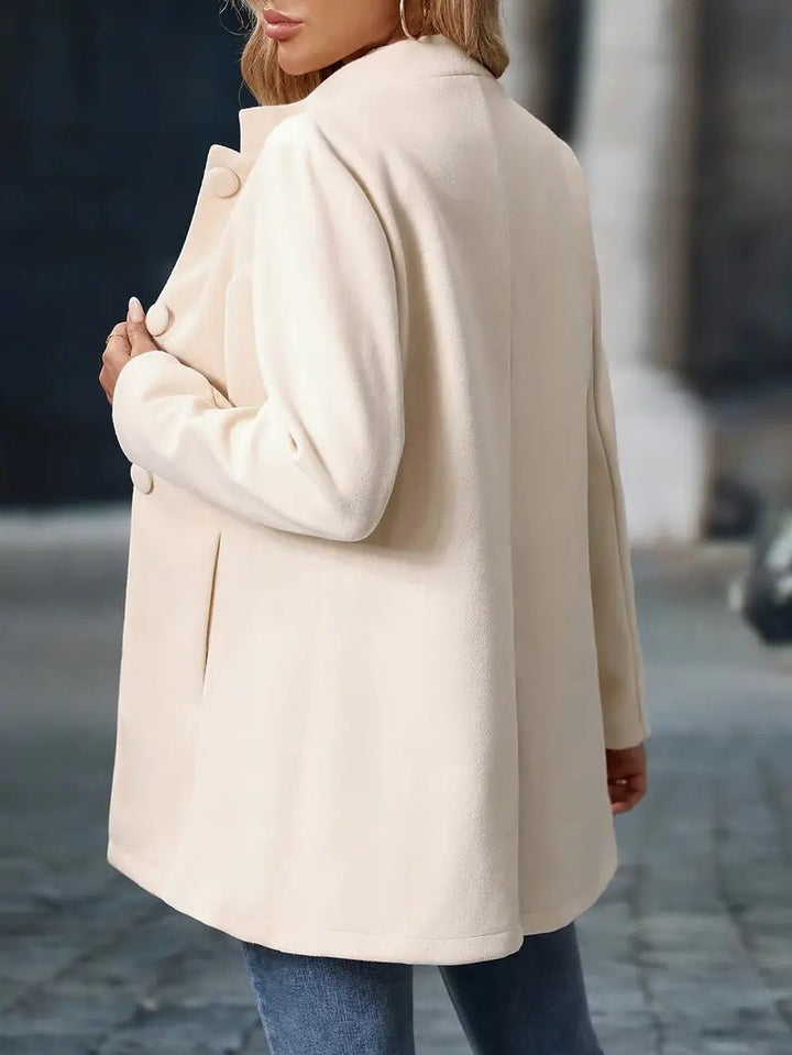 Stylish women's mid-length coat featuring an elegant stand collar. Professional outerwear.