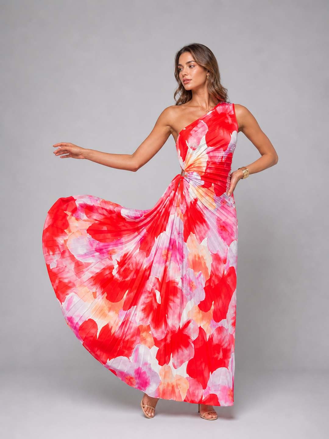 Stylish women's one-shoulder pleated maxi dress in a vibrant floral print, suitable for summer weddings & events.
