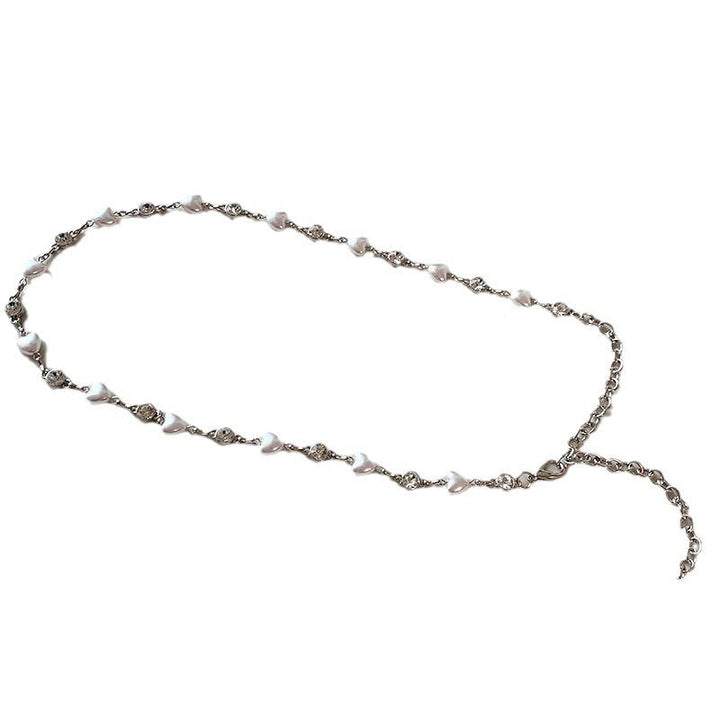 Close-up of a luxurious pearl necklace for women, adorned with intricate heart pendants and a smooth finish.