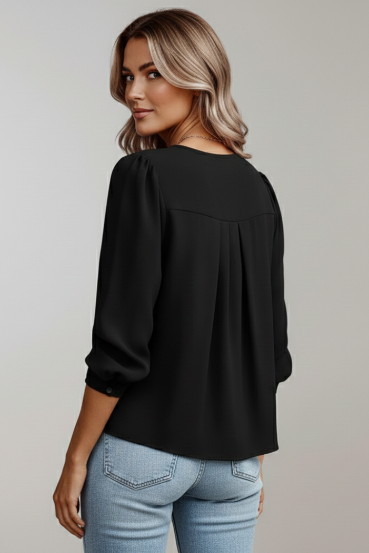 Elegant women's blouse with delicate pleats and stylish puff sleeves, a spring fashion must-have.