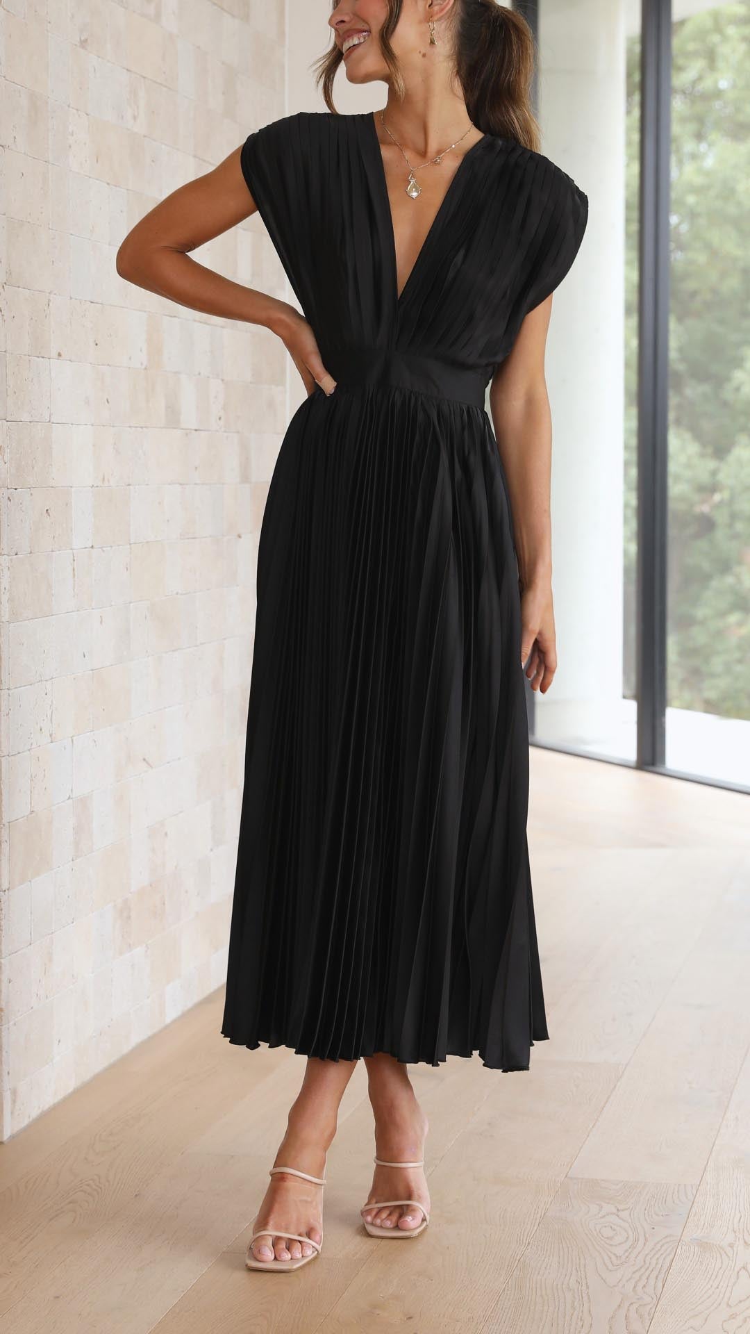Modern elegant V-neck pleated midi dress, perfect for contemporary wedding guests.