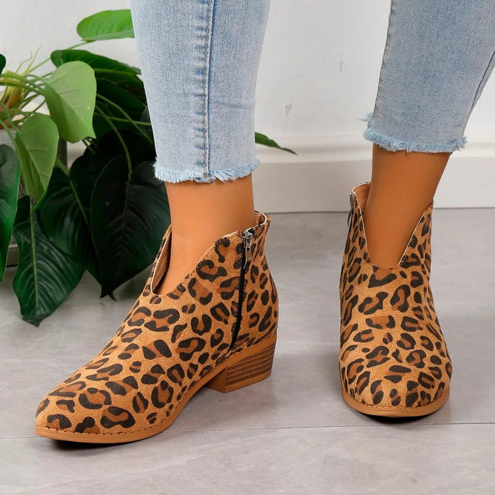 Women's elegant pointed toe ankle boots with stable square heel. Perfect chic footwear.