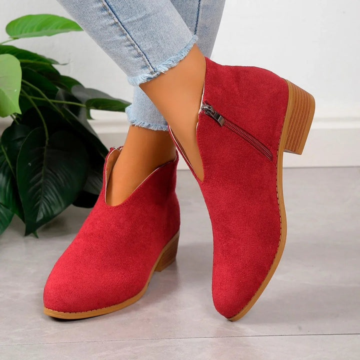 Women's elegant pointed toe ankle boots styled, showcasing the square heel and slip-on ease.