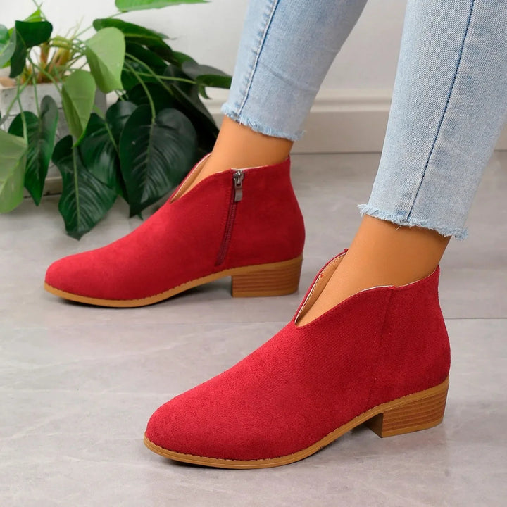 Black elegant pointed toe ankle boots for women, square heel, slip-on, ideal for any occasion.