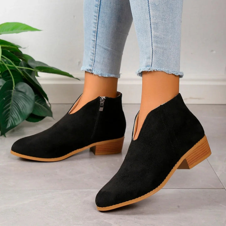Women's elegant slip-on pointed toe ankle boots featuring a stable square heel, everyday comfort.