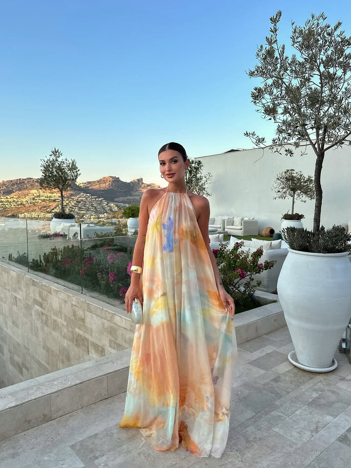 Women's elegant printed halter maxi dress, perfect for summer vacation or beachwear with its flowy design.