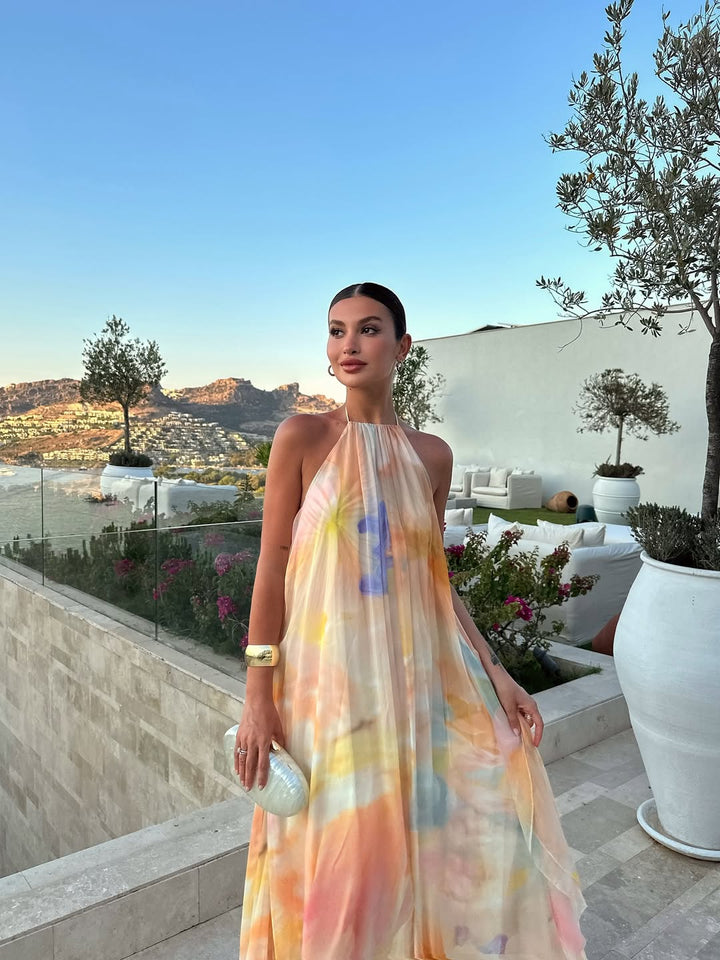 Flowy sleeveless women's printed halter maxi dress, a casual chic summer fashion statement for any occasion.