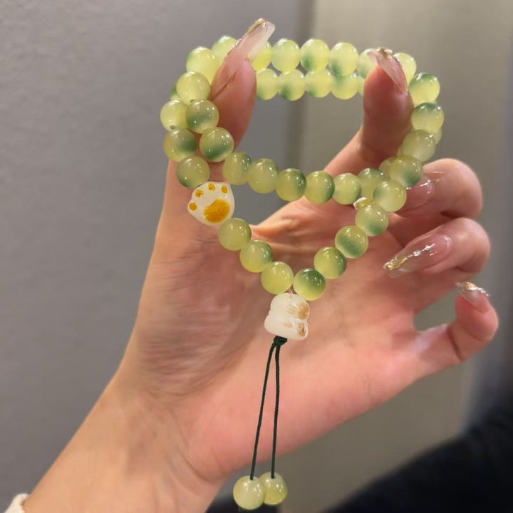 Women's elegant semi-precious stone friendship bracelet with pink and green beads, adjustable fit.