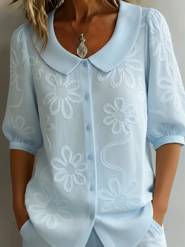Versatile women's floral embroidered shirt. Short sleeve, round neck blouse for elegant casual spring & summer fashion.
