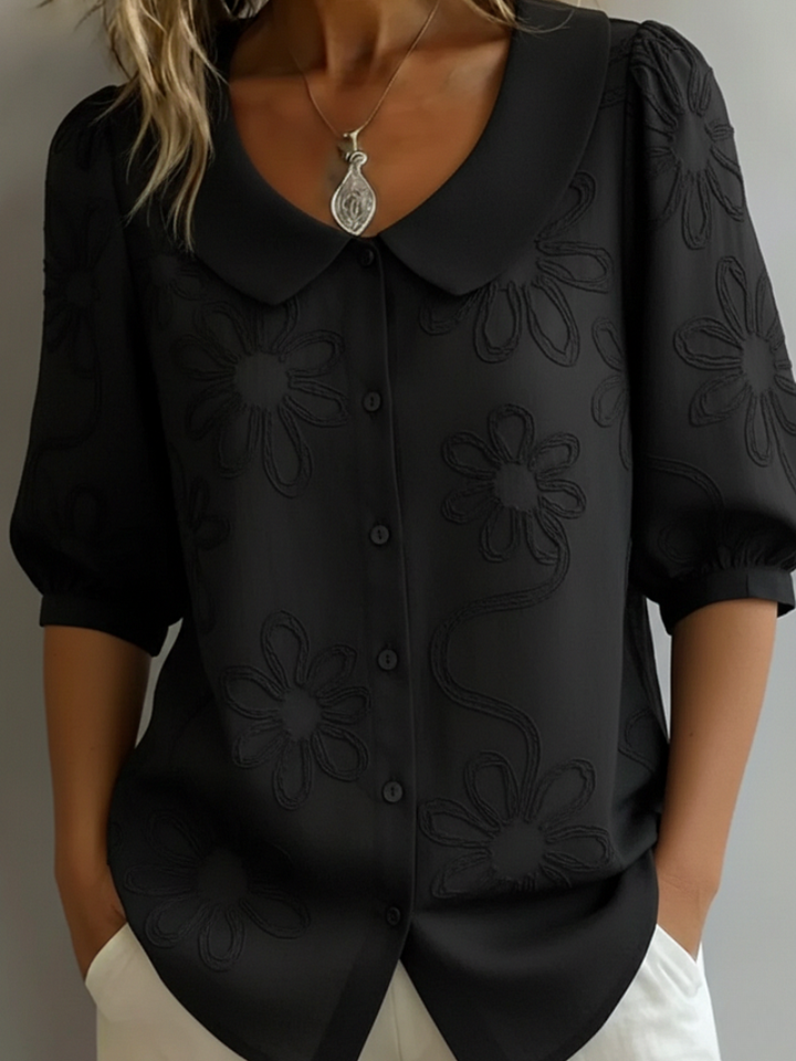 Beautiful women's floral embroidered short sleeve blouse. Round neck, relaxed fit top for comfortable, elegant everyday wear.