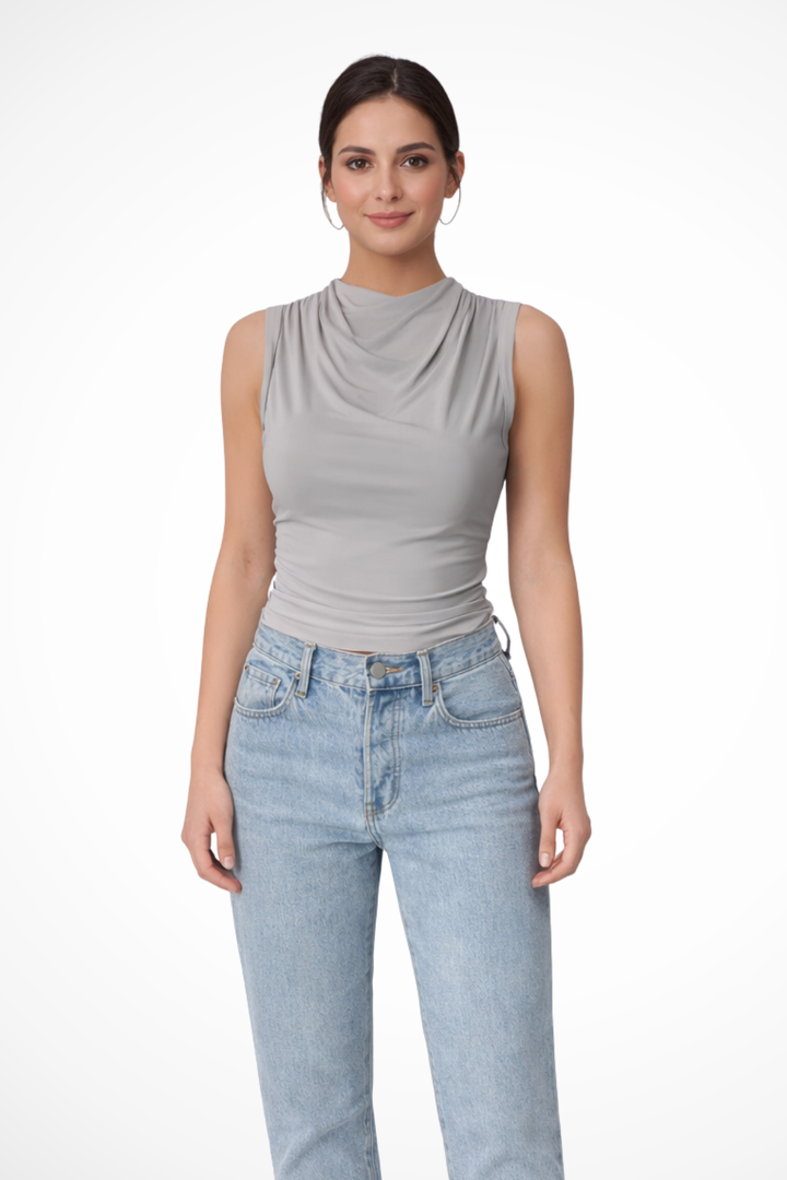 Elegant women's sleeveless peplum top featuring a graceful draped neck. A versatile chic blouse.