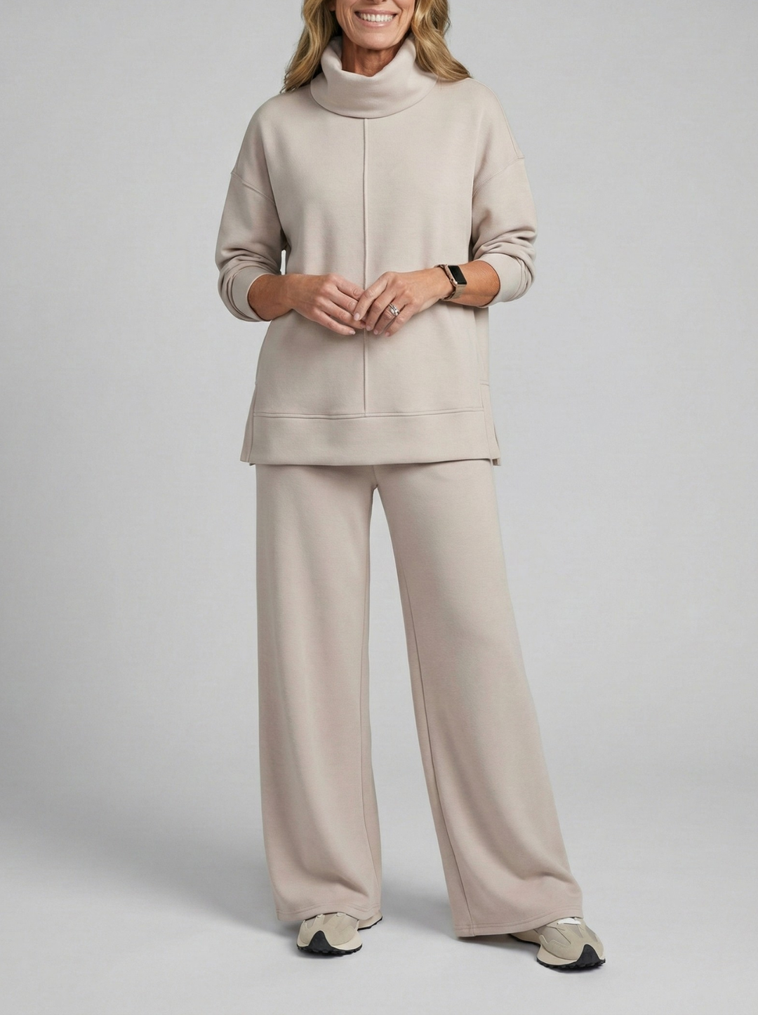 Comfortable women's two-piece lounge set, soft fabric pullover & pants for relaxed fit and everyday elegance.