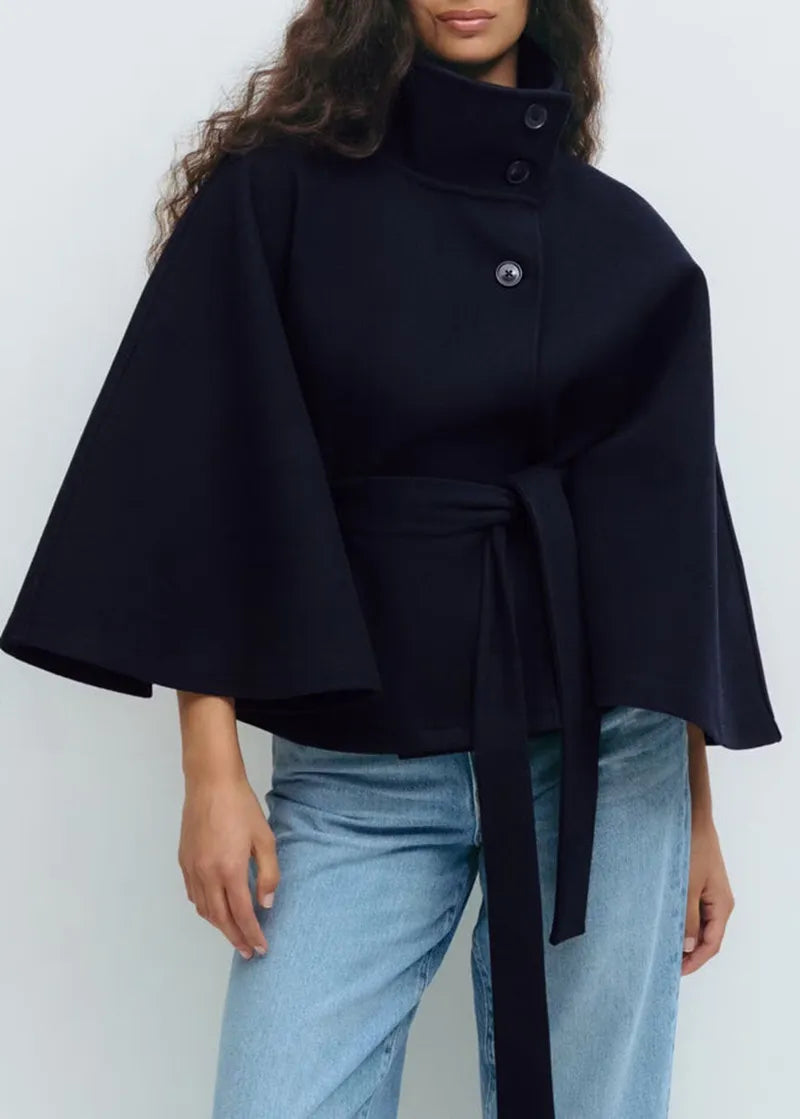 Stylish woman wearing a belted high-neck spring cape coat, perfect for elegant fashion & layering.