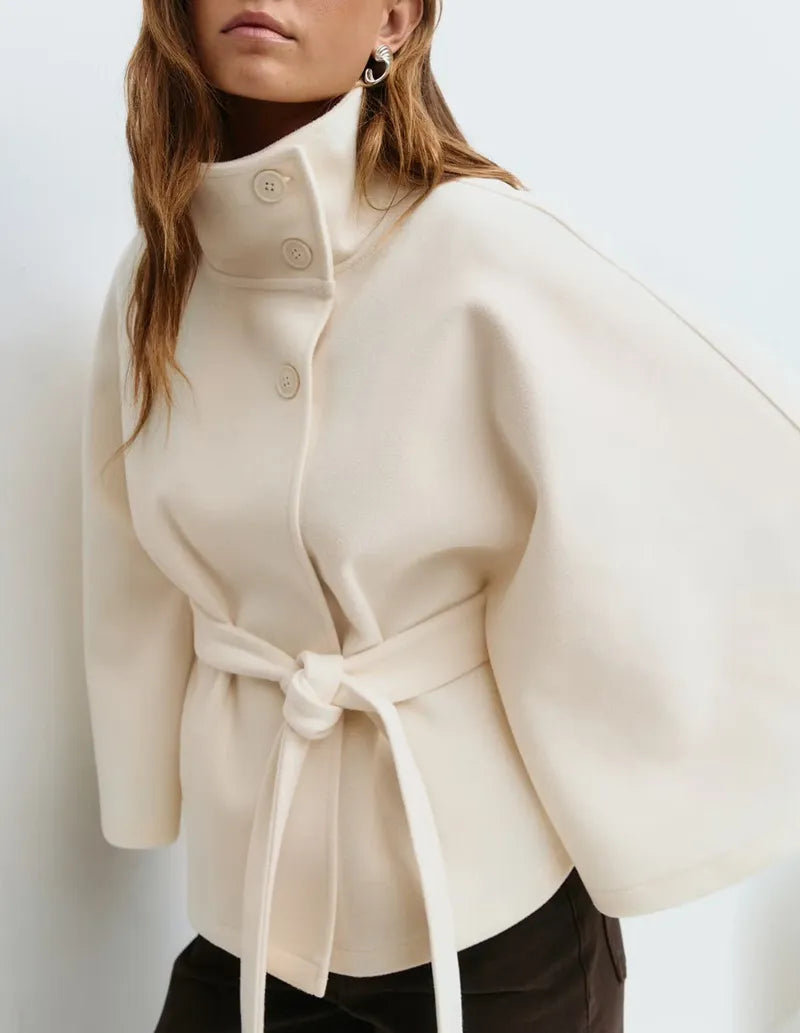 Fashionable women's spring cape coat. High-neck & belted design for a chic, elegant outerwear look.