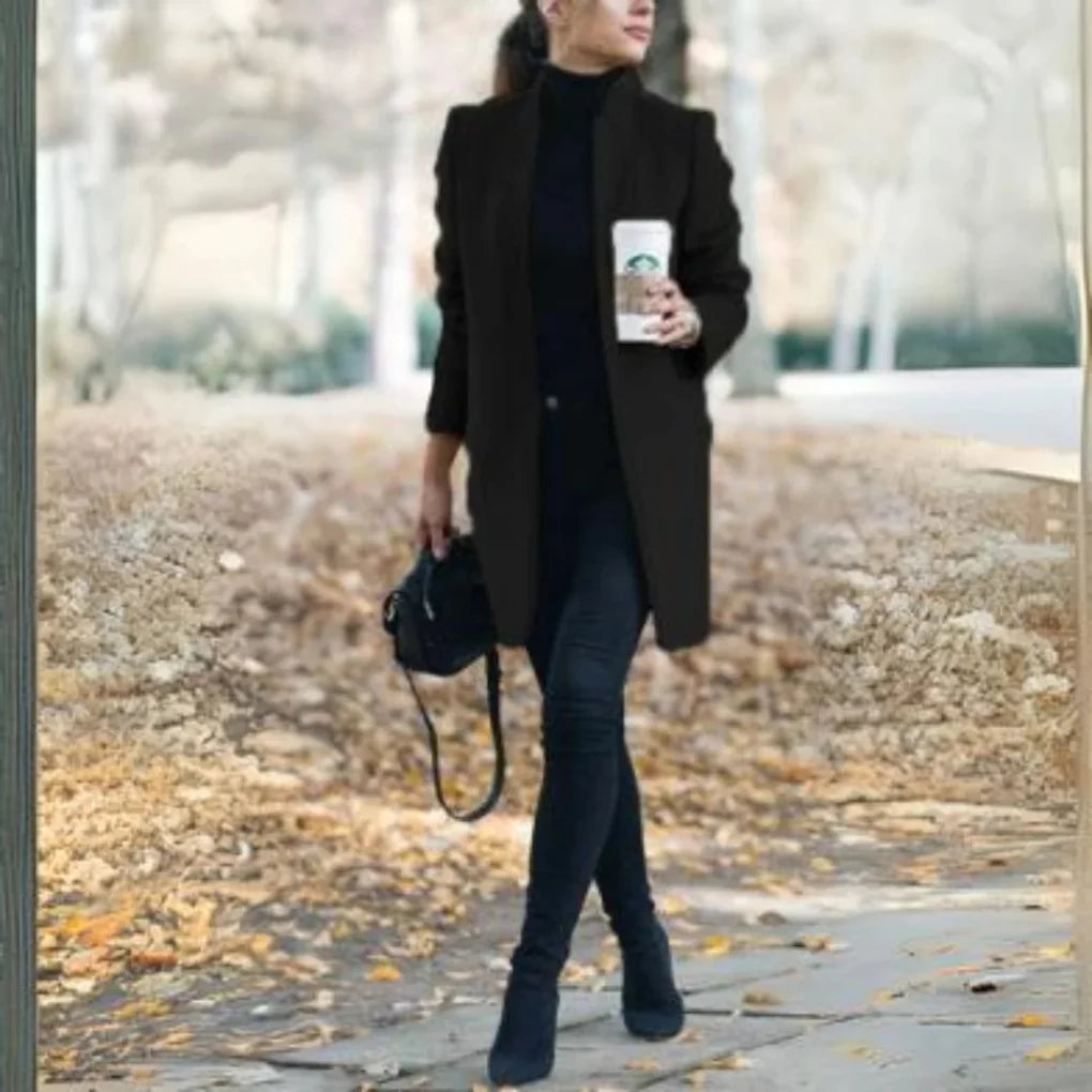Long women's fashion winter coat with an elegant stand collar. Perfect structured outerwear for chic cold weather style.