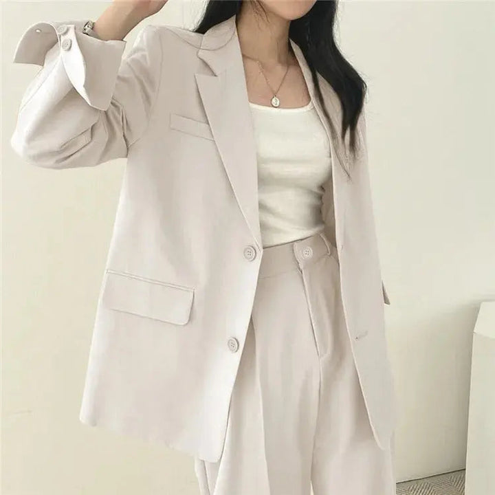 Sophisticated women's business attire, a perfectly tailored blazer and pant set.