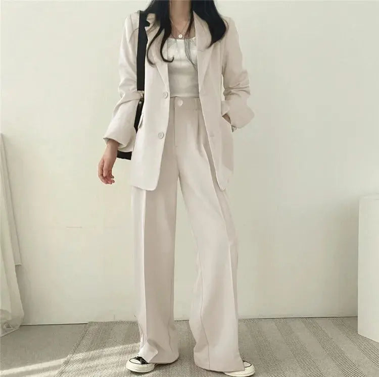 Modern women's formal suit with a sleek tailored blazer & matching trousers.