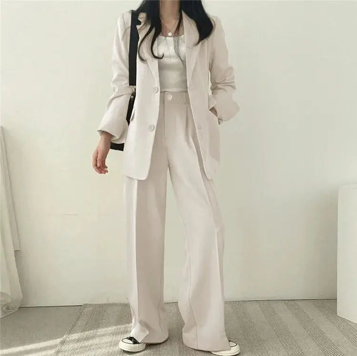 Modern women's formal suit with a sleek tailored blazer & matching trousers.