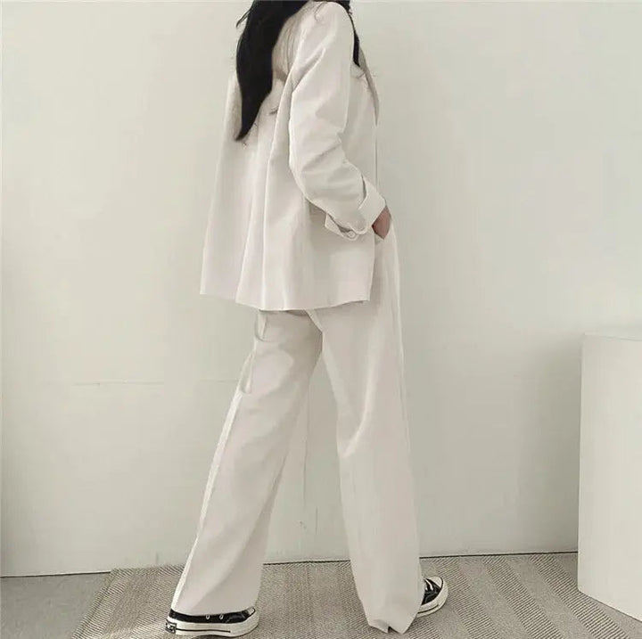 Professional women's elegant blazer and trouser set, versatile for business.