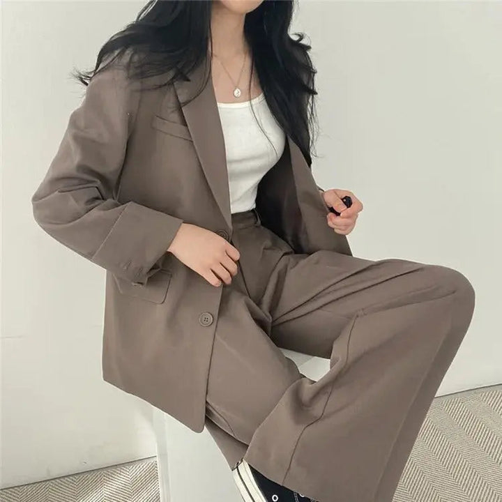 Modern women's business suit, featuring a sleek tailored blazer & relaxed trousers.