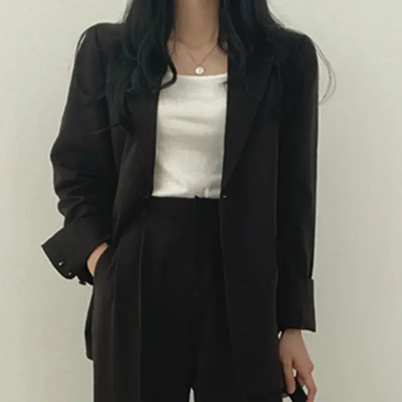 Stylish women's business outfit: a contemporary blazer and trouser combination.