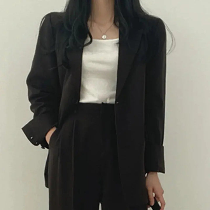 Stylish women's business outfit: a contemporary blazer and trouser combination.