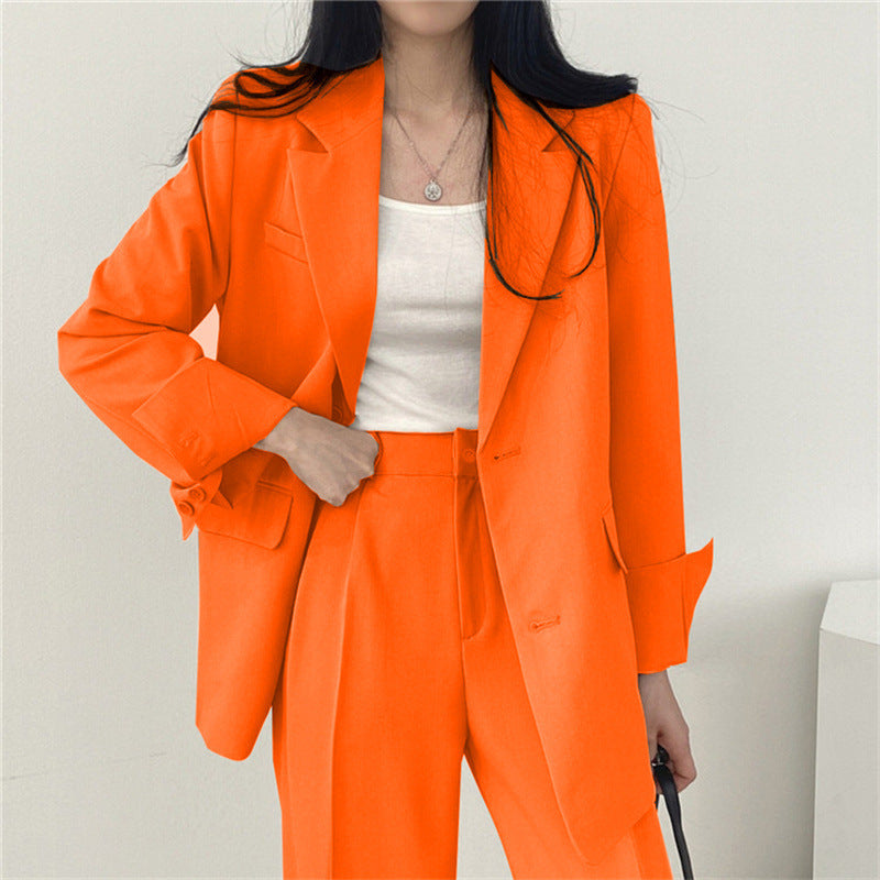Elegant women's work suit, combining a classic blazer with modern tailored trousers.