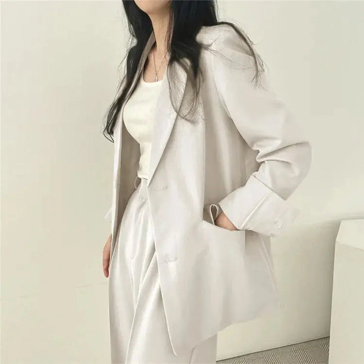Stylish two-piece women's set, combining a blazer & relaxed trousers for business.