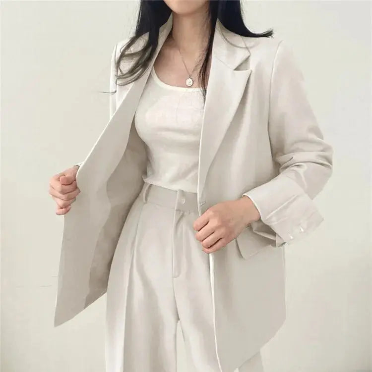 Chic women's workwear: tailored blazer and trouser ensemble for the office.