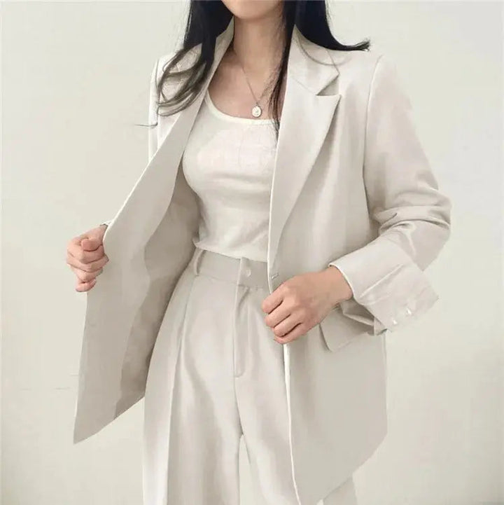 Chic women's workwear: tailored blazer and trouser ensemble for the office.