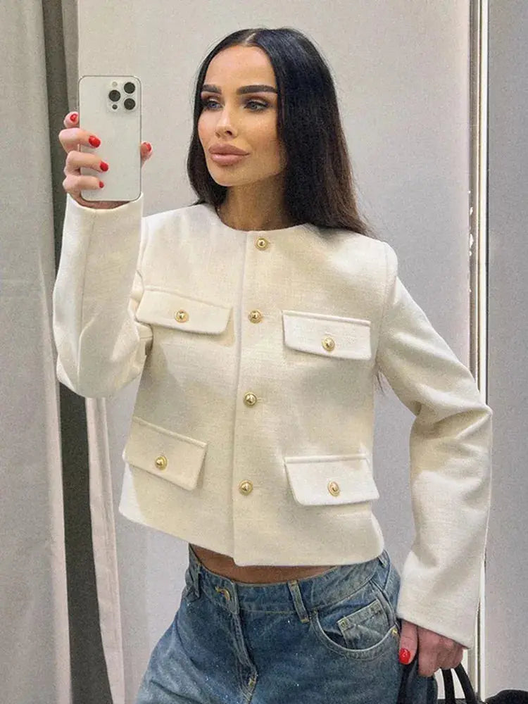 Modern women's cropped button-up jacket. Elegant textured design, perfect for smart casual layering.