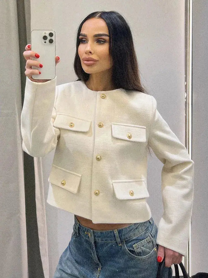 Modern women's cropped button-up jacket. Elegant textured design, perfect for smart casual layering.