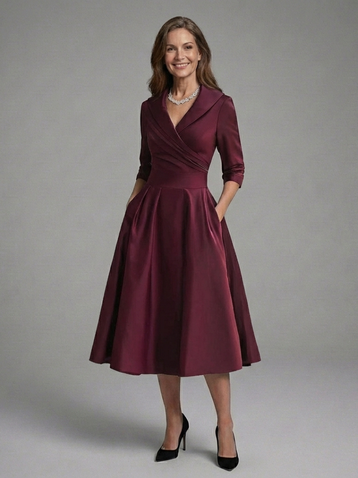 Chic women's wrap dress, midi length, with three-quarter sleeves and a sophisticated flared skirt.