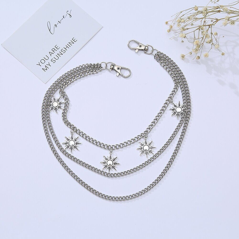Women's elegant triple chain necklace with a shining sun motif pendant. Perfect fashion accessory.