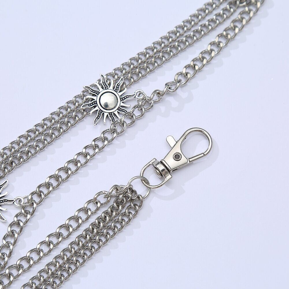 Close-up: Elegant women's triple chain necklace, showcasing the intricate sun motif pendant design.