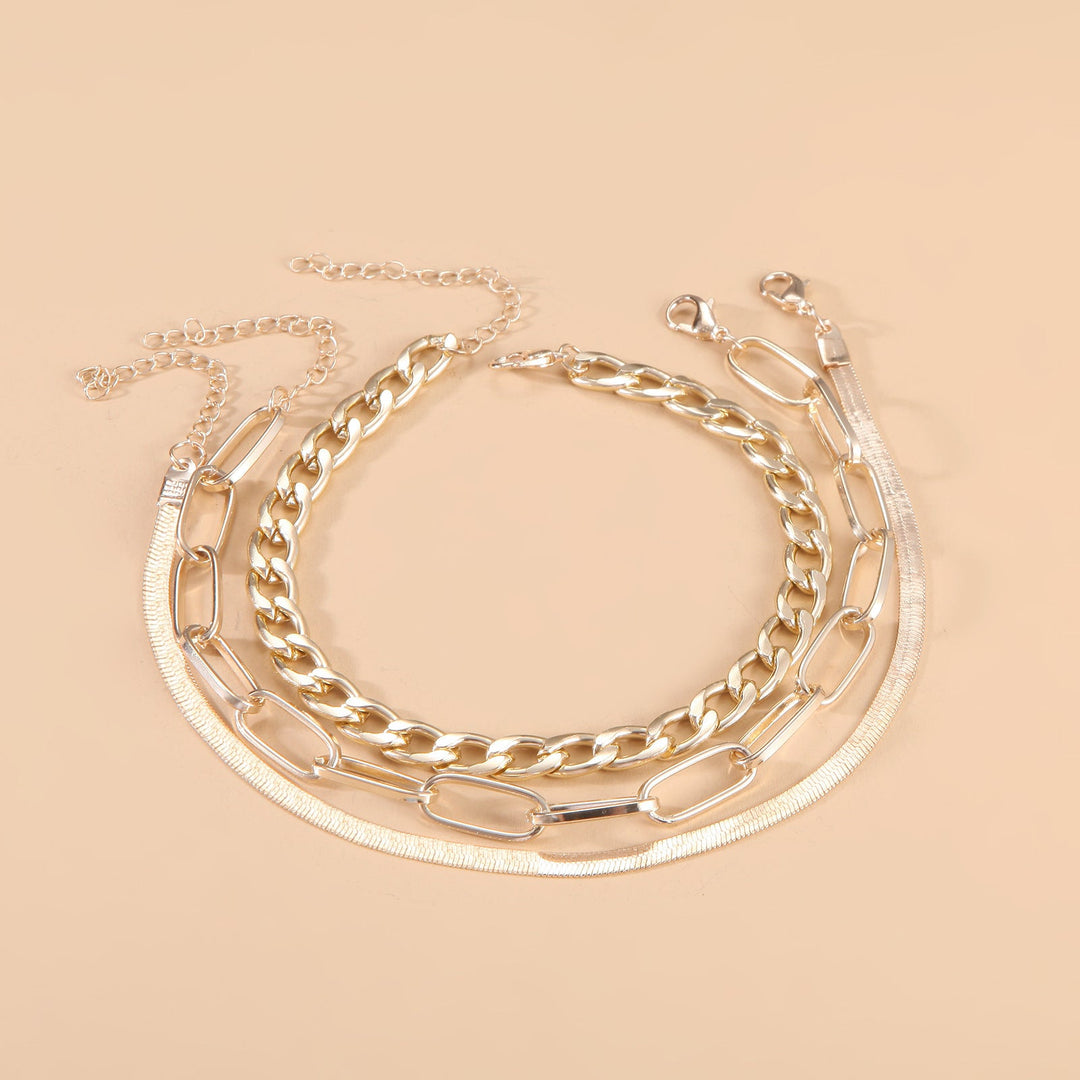 Shimmering silver and gold tone twisted chain bracelet for women, an elegant adjustable fashion accessory.