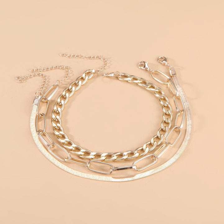 Shimmering silver and gold tone twisted chain bracelet for women, an elegant adjustable fashion accessory.