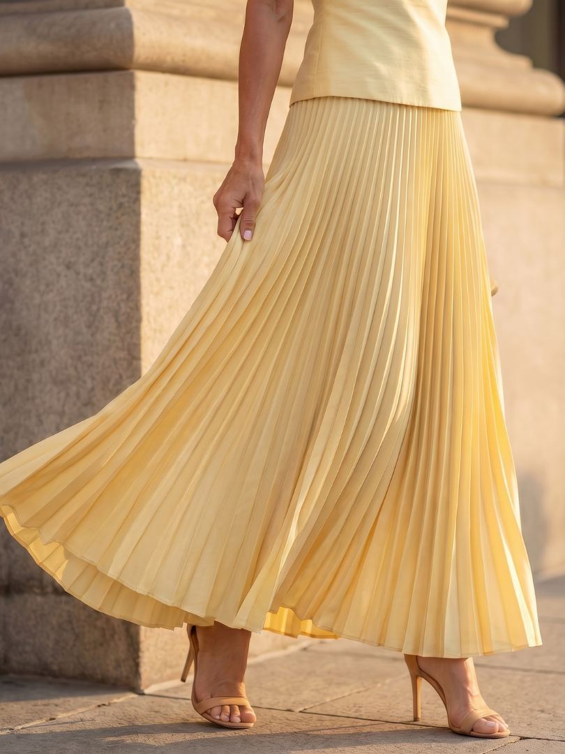 Modern pleated skirt with flowing movement, part of an elegant women's matching set.