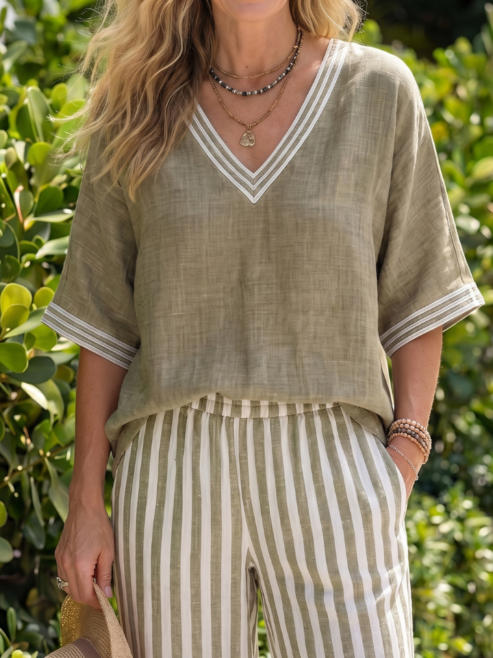 Coordinated women's V-neck tunic and striped wide-leg trousers set, perfect for summer casual.