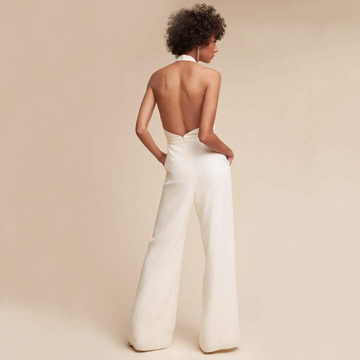 Modern women's wide-leg jumpsuit. Elegant halter neck and deep V design. A chic sleeveless one-piece for fashion.