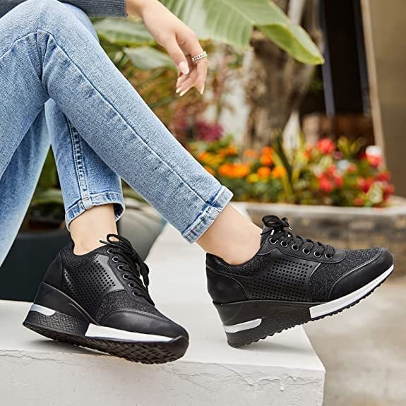 Women's elevated wedge sneakers, white, with a chunky platform sole. Stylish and comfortable casual footwear.