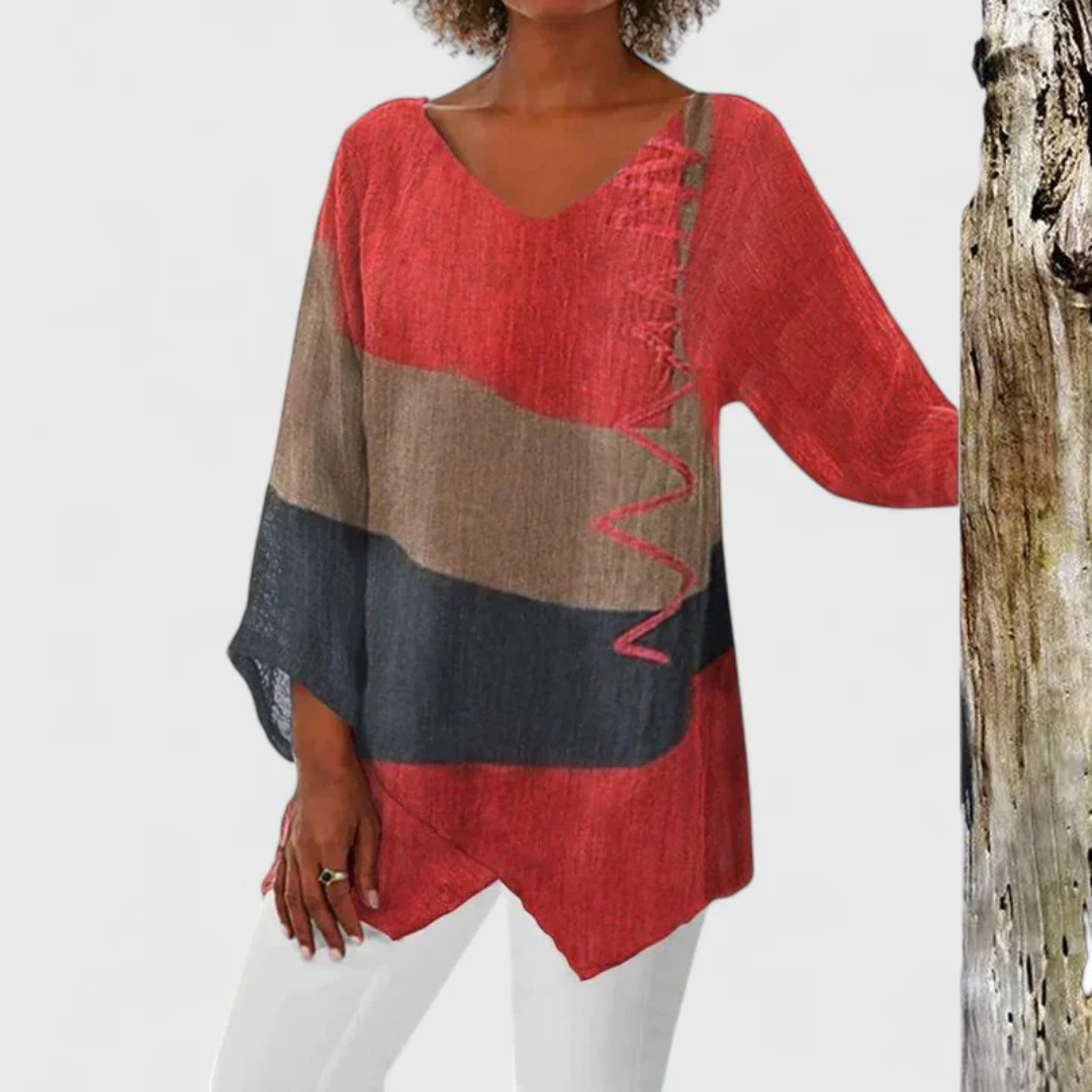 Women's Elysia V-neck tunic top with an artistic colorful print and stylish asymmetrical hem for casual chic.